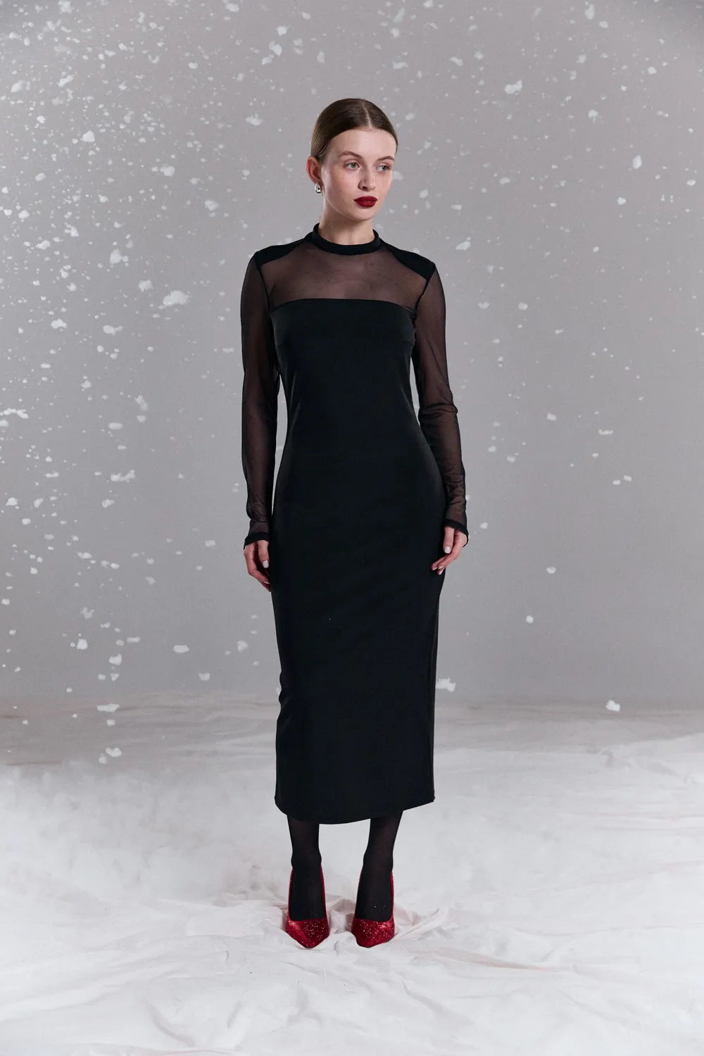 Black fitted dress with elegant mesh inserts