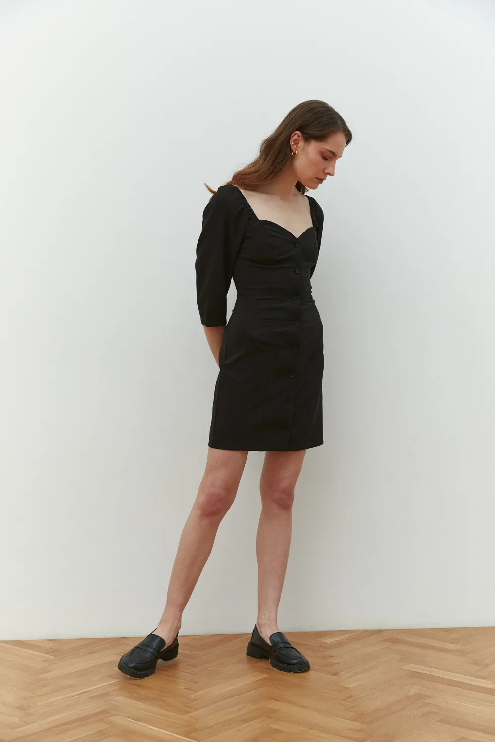Black fitted mini dress with deep neckline
